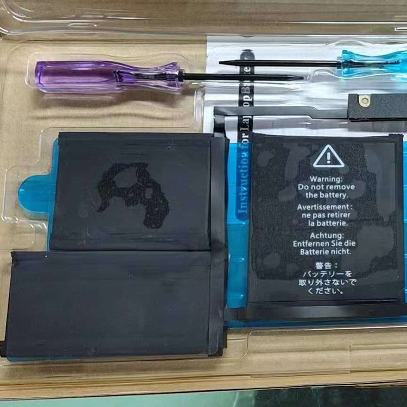 Two batteries and a screwdriver in a clear plastic case with warning labels.