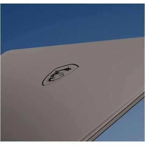 Gray surface with a black logo against a blue sky