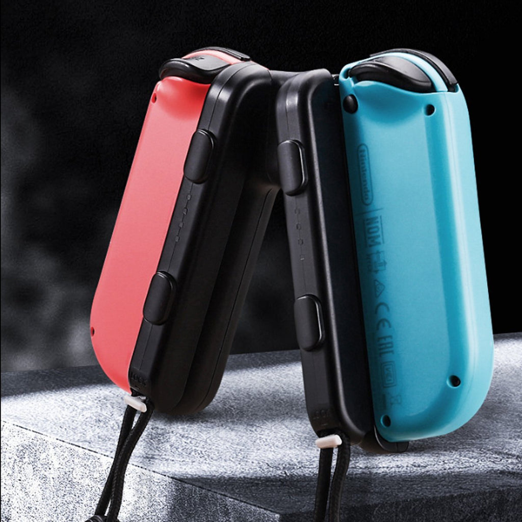 Two folding knives, one red and one blue, on a dark background.