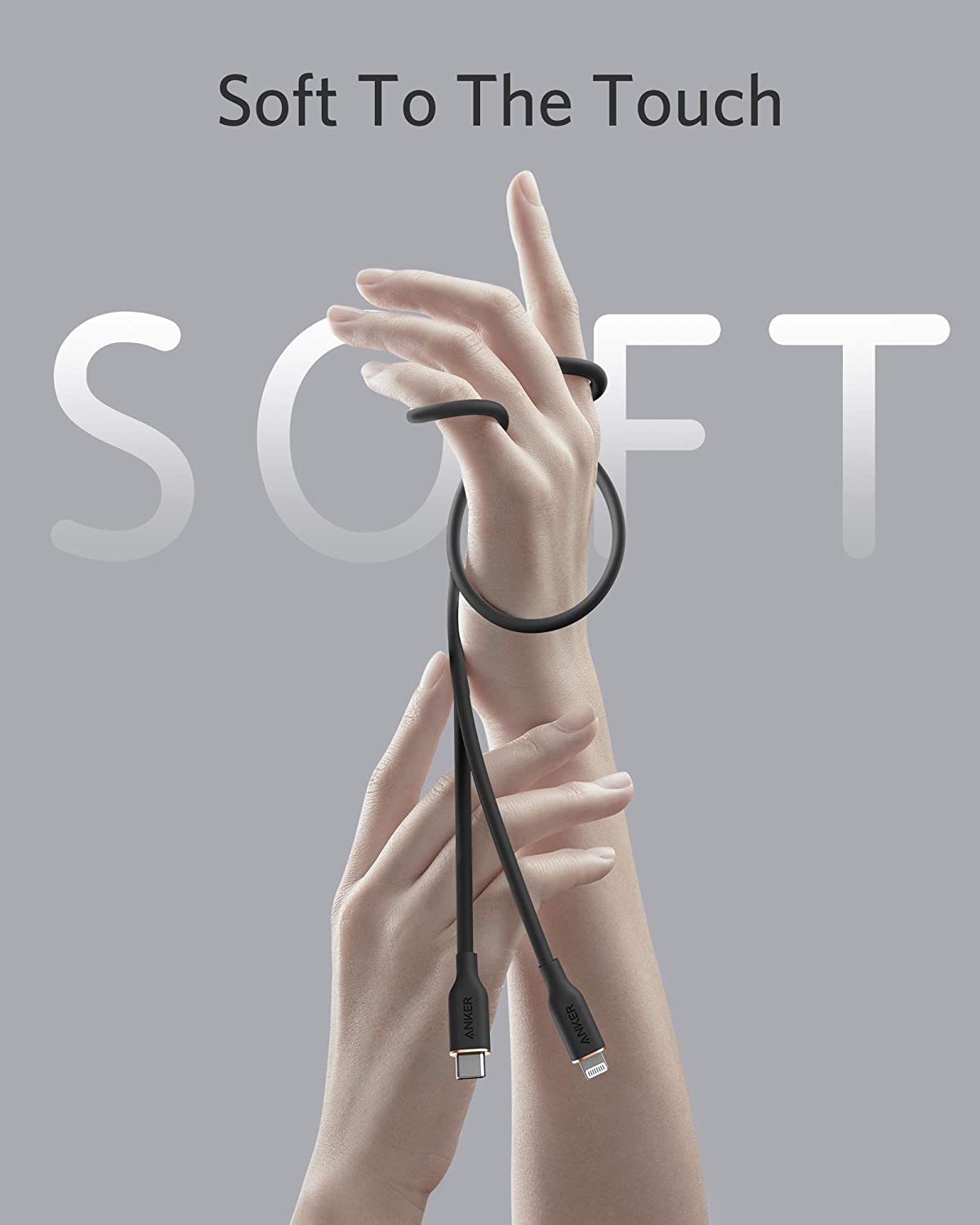 Hand holding a black cable with 'Soft To The Touch' text on a gray background