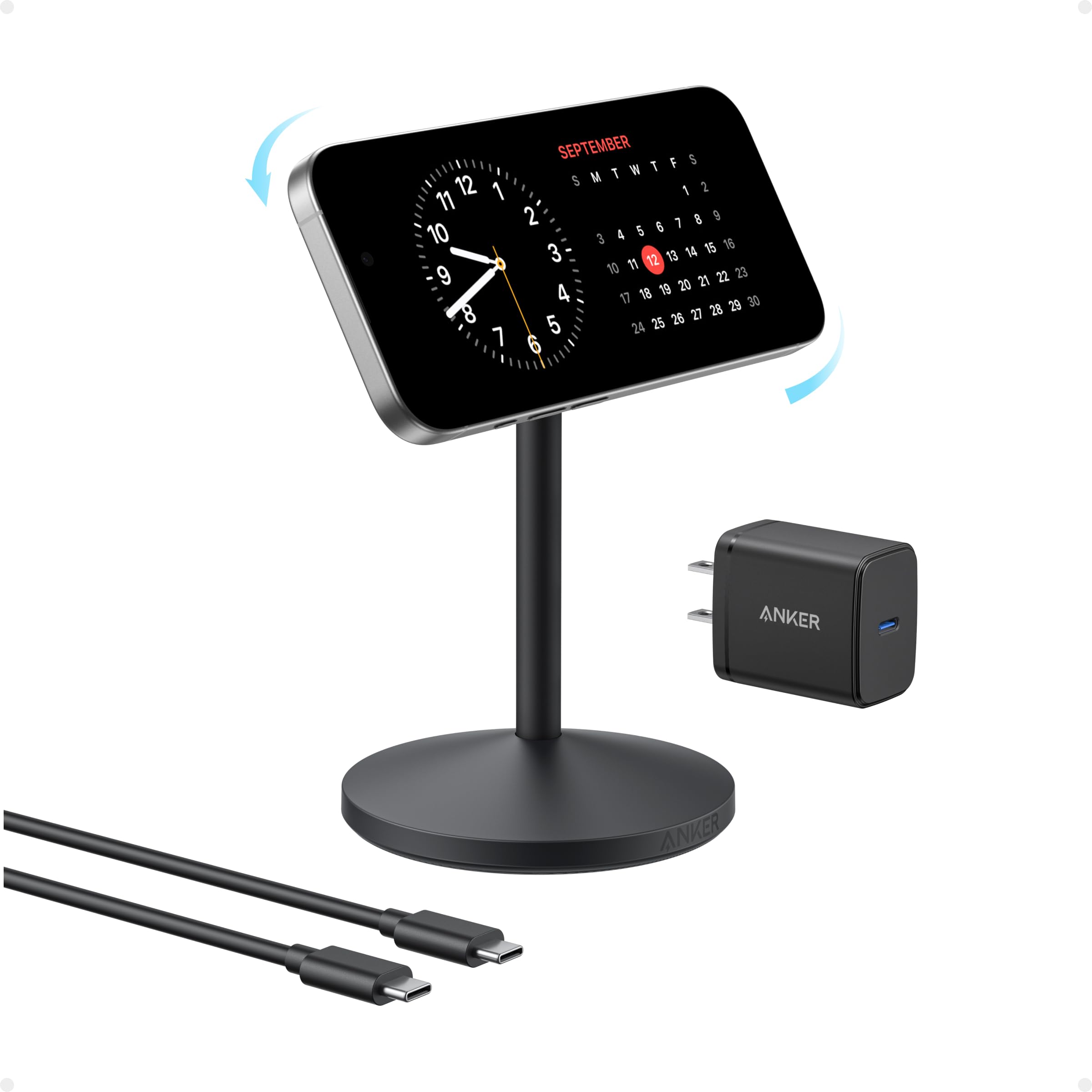 Black phone stand with digital clock, Anker charger, and cables on a white background