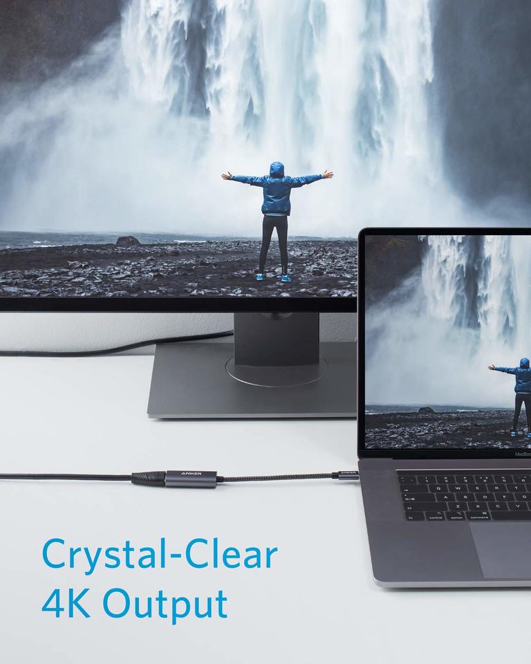 Laptop displaying a scenic image of a person at a waterfall with a monitor showing the same image, emphasizing 4K output.
