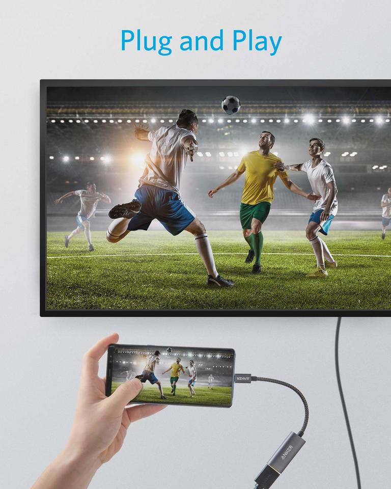 Smartphone displaying a soccer game on a TV screen with 'Plug and Play' text above.