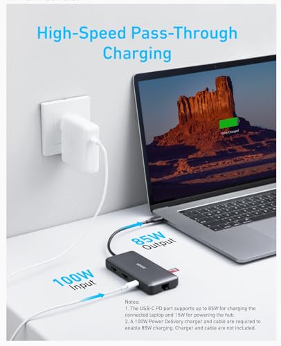 Laptop with USB-C hub and power adapter on a white surface, displaying 'High-Speed Pass-Through Charging'.