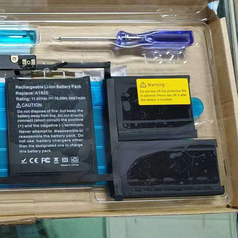 Rechargeable Li-ion battery pack with tools and warning label in a clear box.