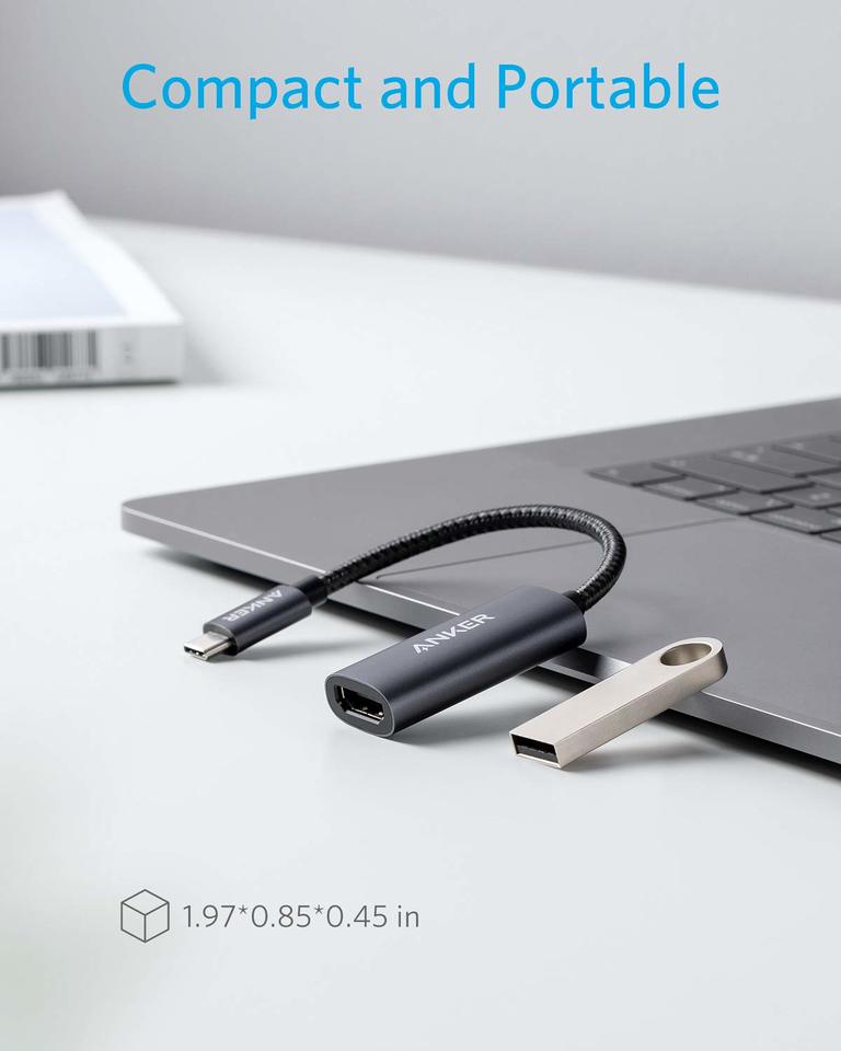 Compact USB adapter with a laptop on a light gray background