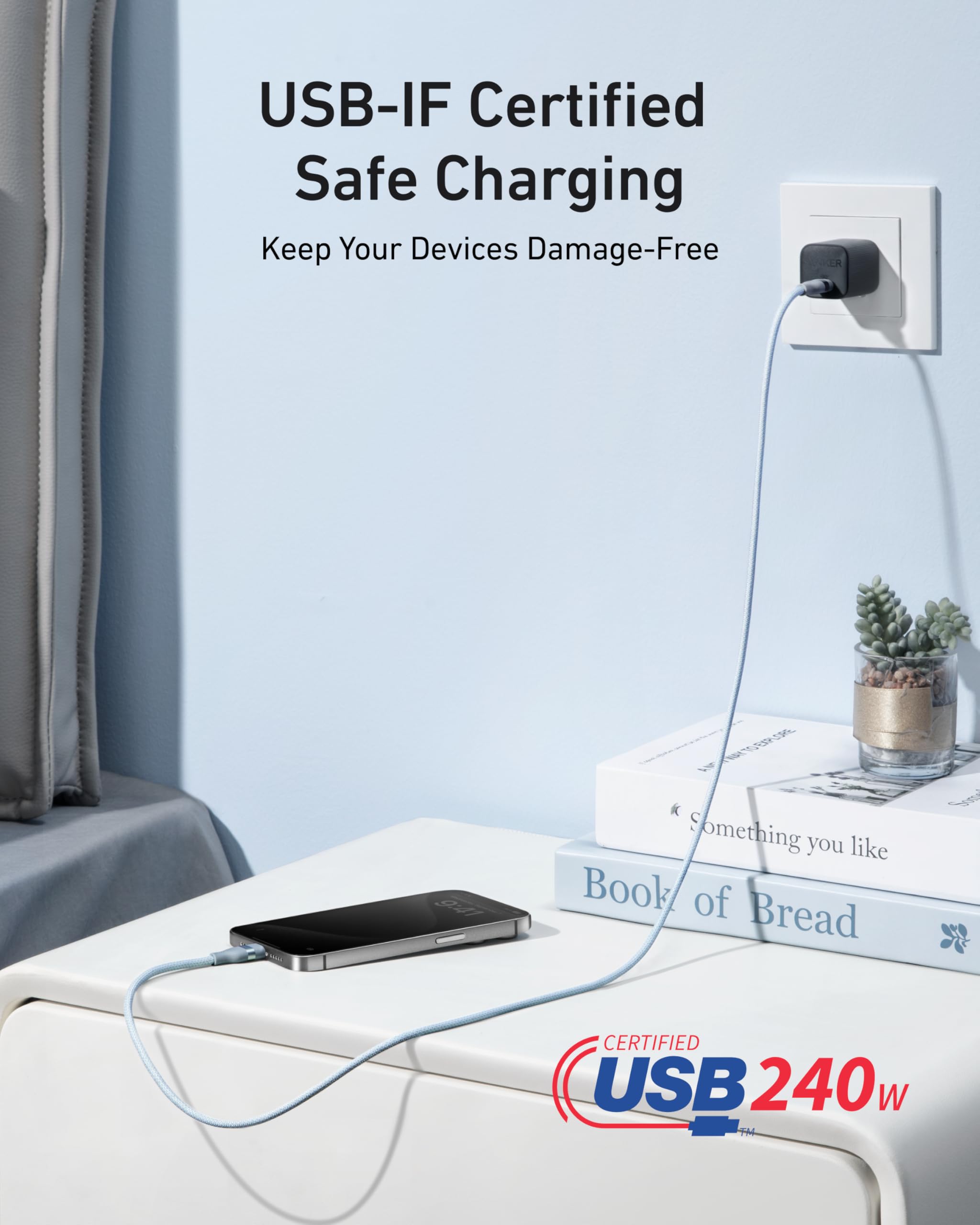 USB charging cable connected to a device on a surface with a light blue wall in the background.