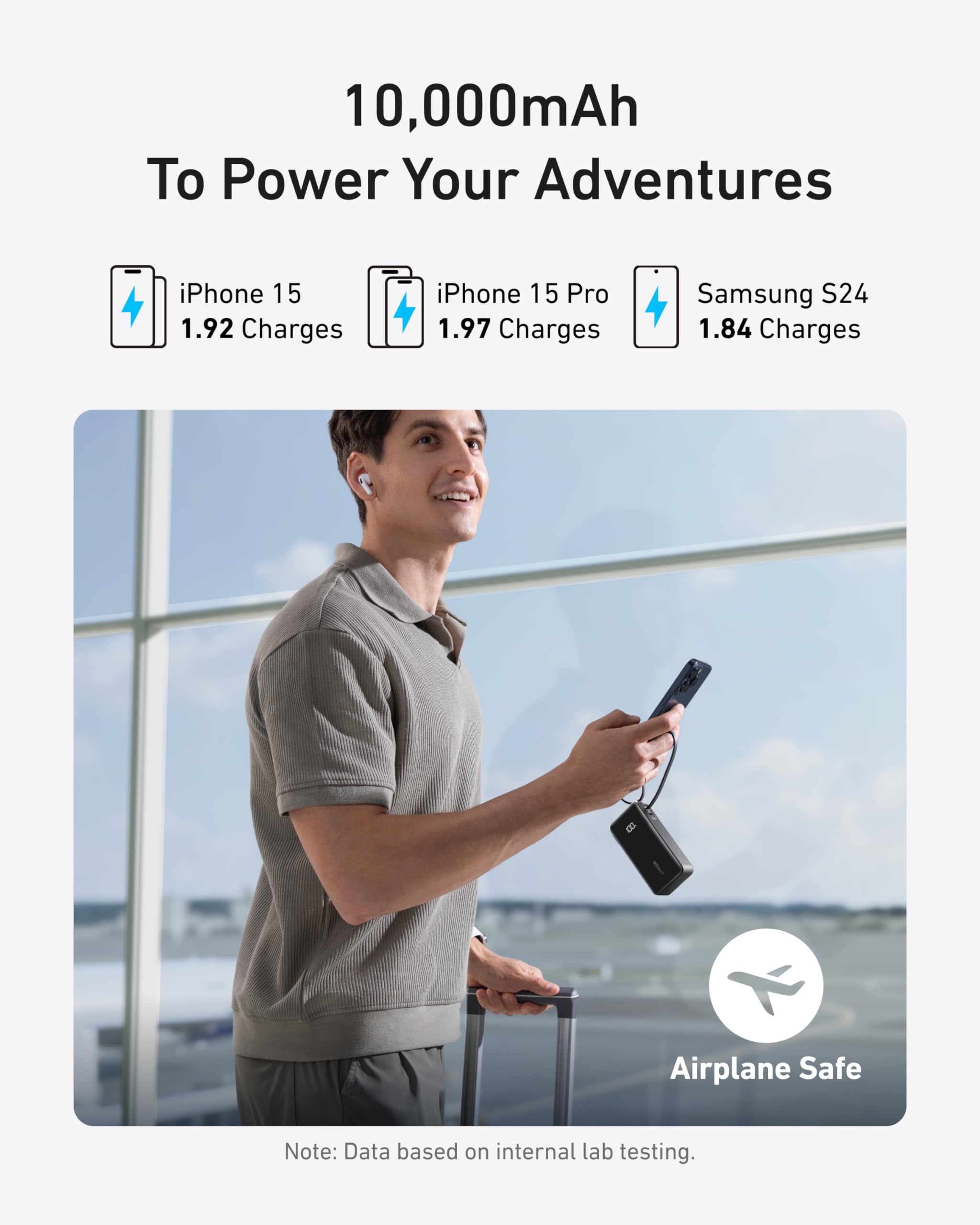Person holding a portable power bank with charging information displayed above.