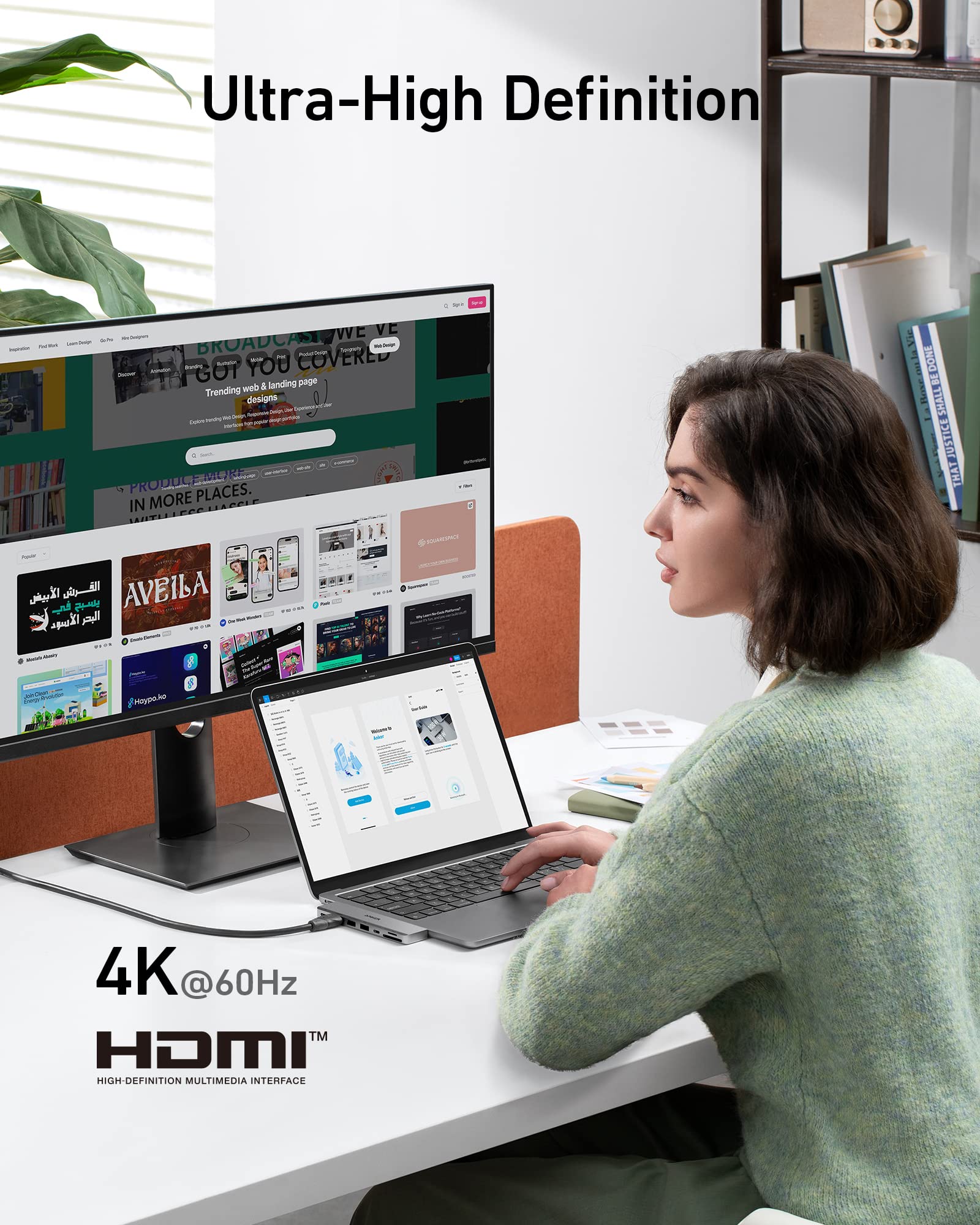 Person using a laptop with a large monitor displaying multiple web pages, emphasizing Ultra-High Definition and HDMI technology.