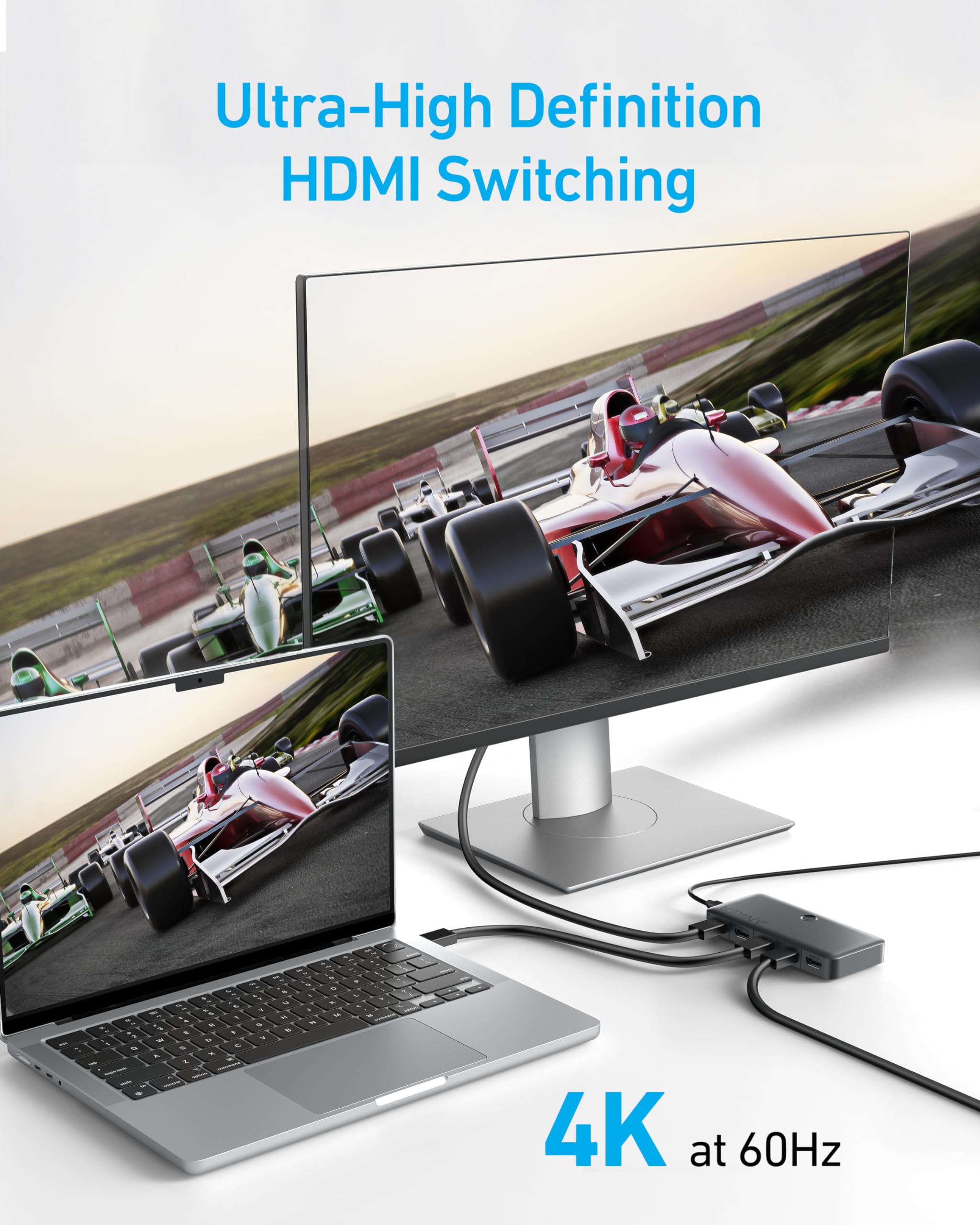 Ultra-High Definition HDMI switching system with laptop and monitor displaying racing game.