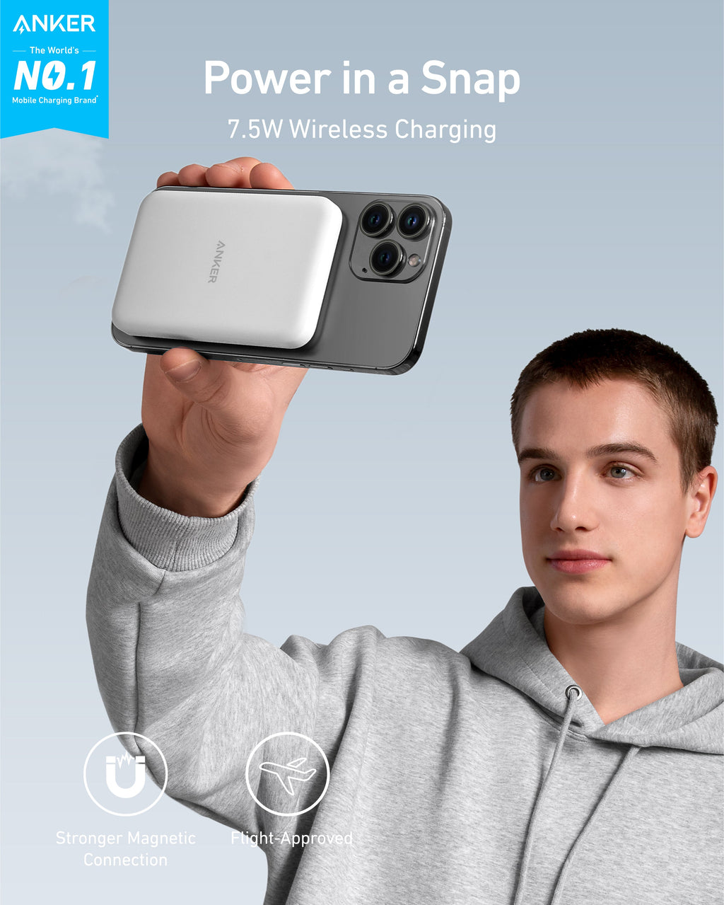 Person holding a smartphone with a wireless charging case, featuring Anker branding.