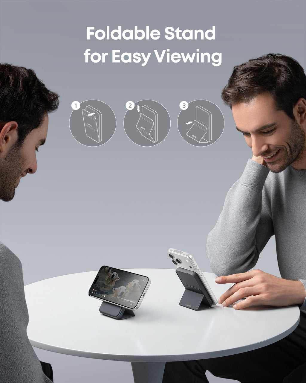 Two men using foldable stands to view smartphone screens at a table with text 'Foldable Stand for Easy Viewing'.