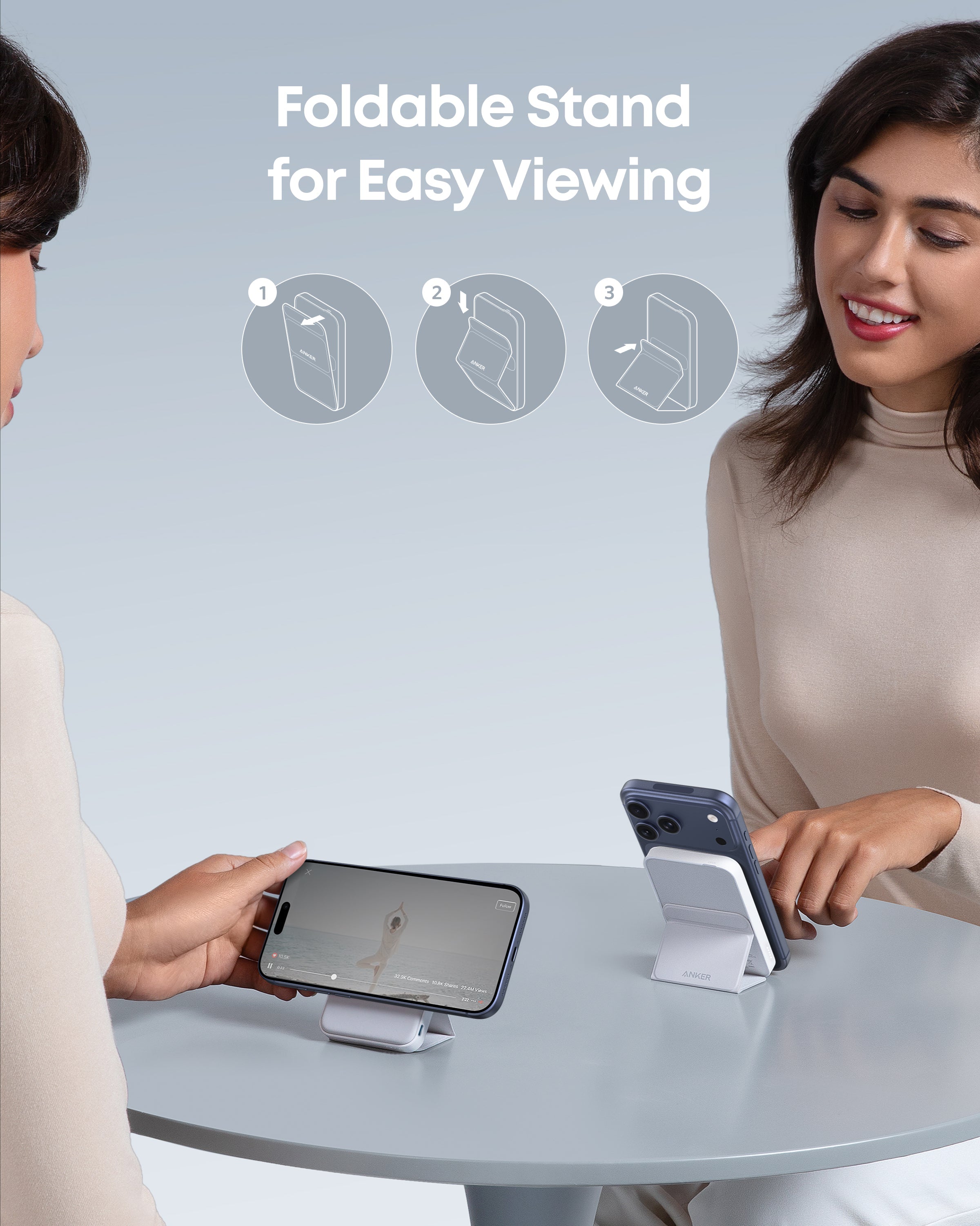 Two people using foldable stands for their smartphones on a table with a light gray background.