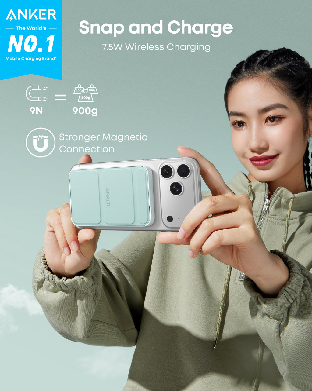 Person holding a phone with Anker wireless charging case against a light blue background