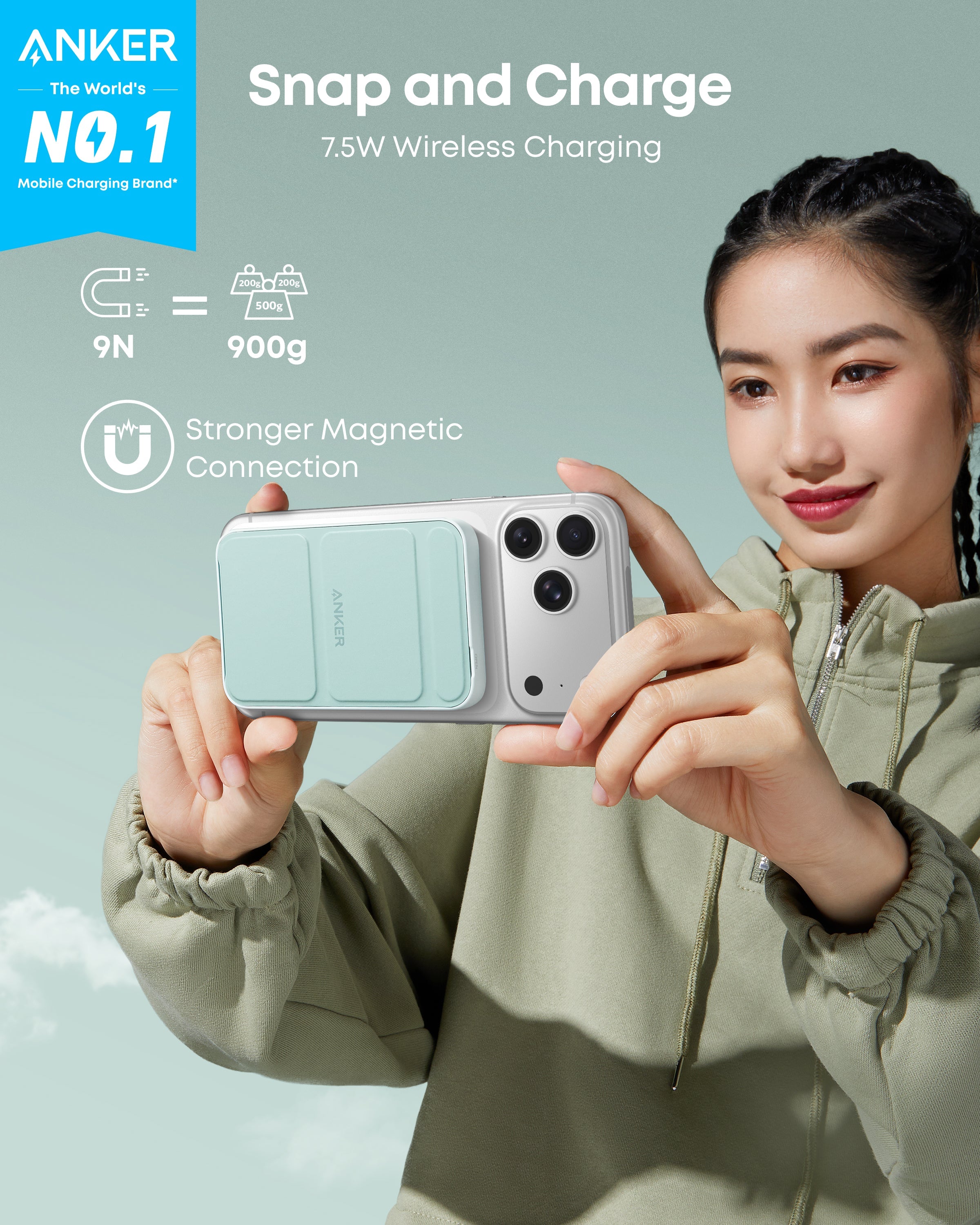 Person holding a phone with Anker wireless charging case against a light blue background