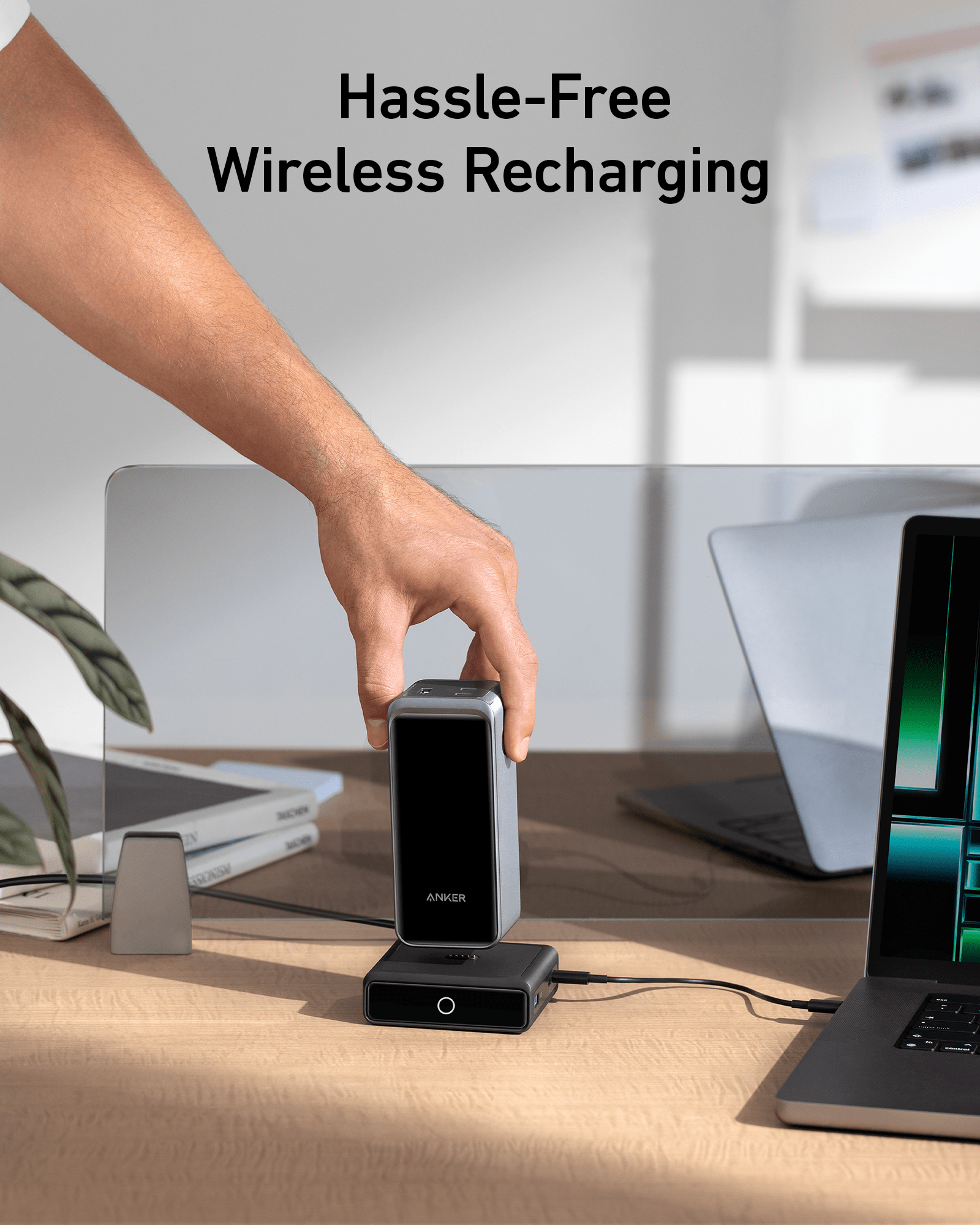 Hand placing a device on a wireless charging pad with text 'Hassle-Free Wireless Recharging' in a modern office setting.