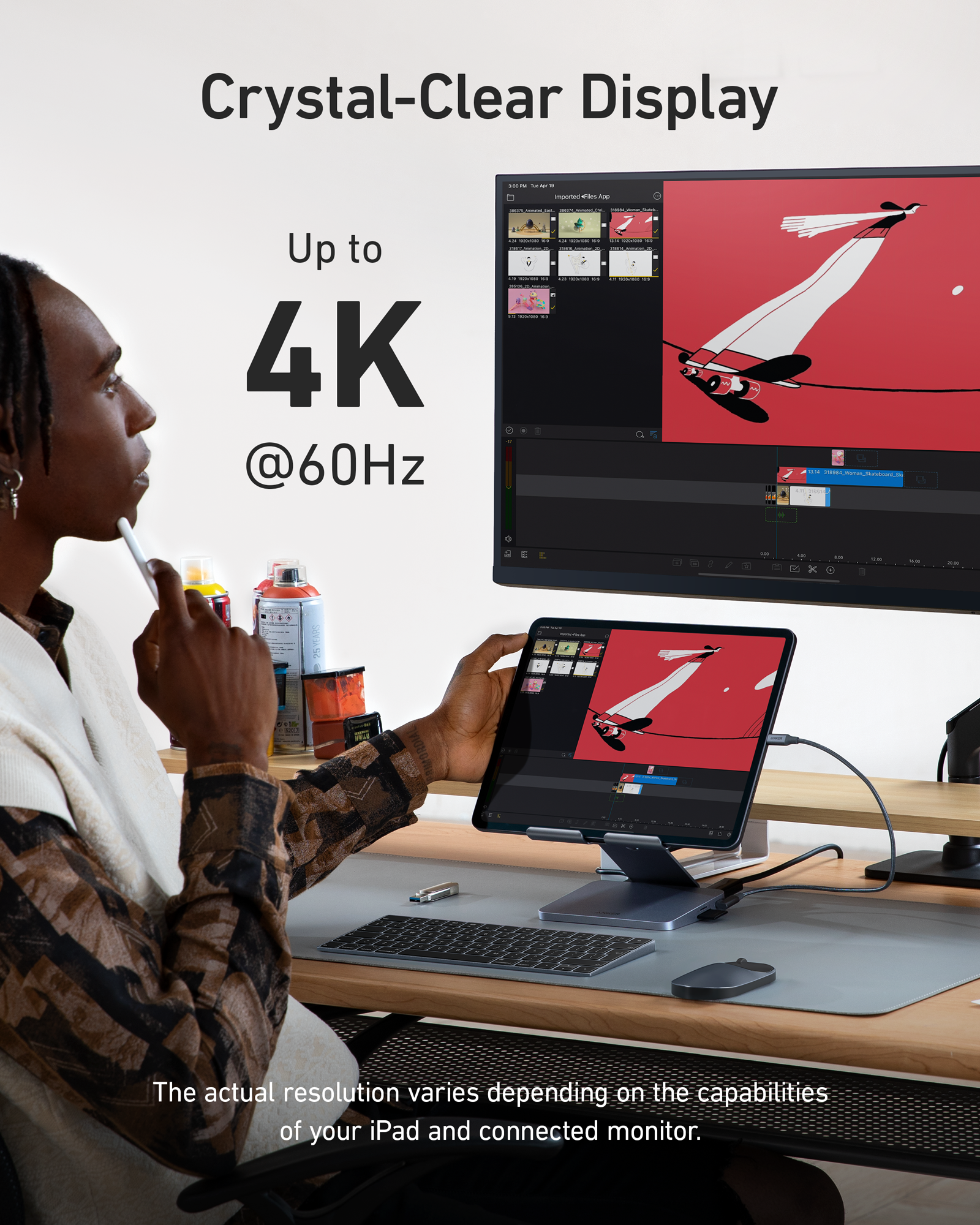 Person using a tablet with a computer monitor displaying a 4K resolution image.