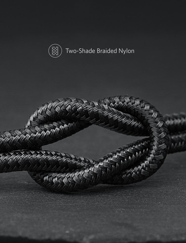 Two-shade braided nylon rope knot on a dark background
