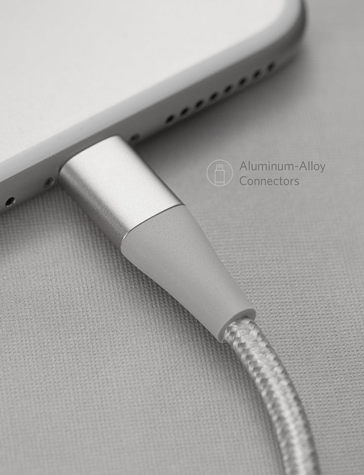 Close-up of a gray charging cable with aluminum alloy connector on a light gray background
