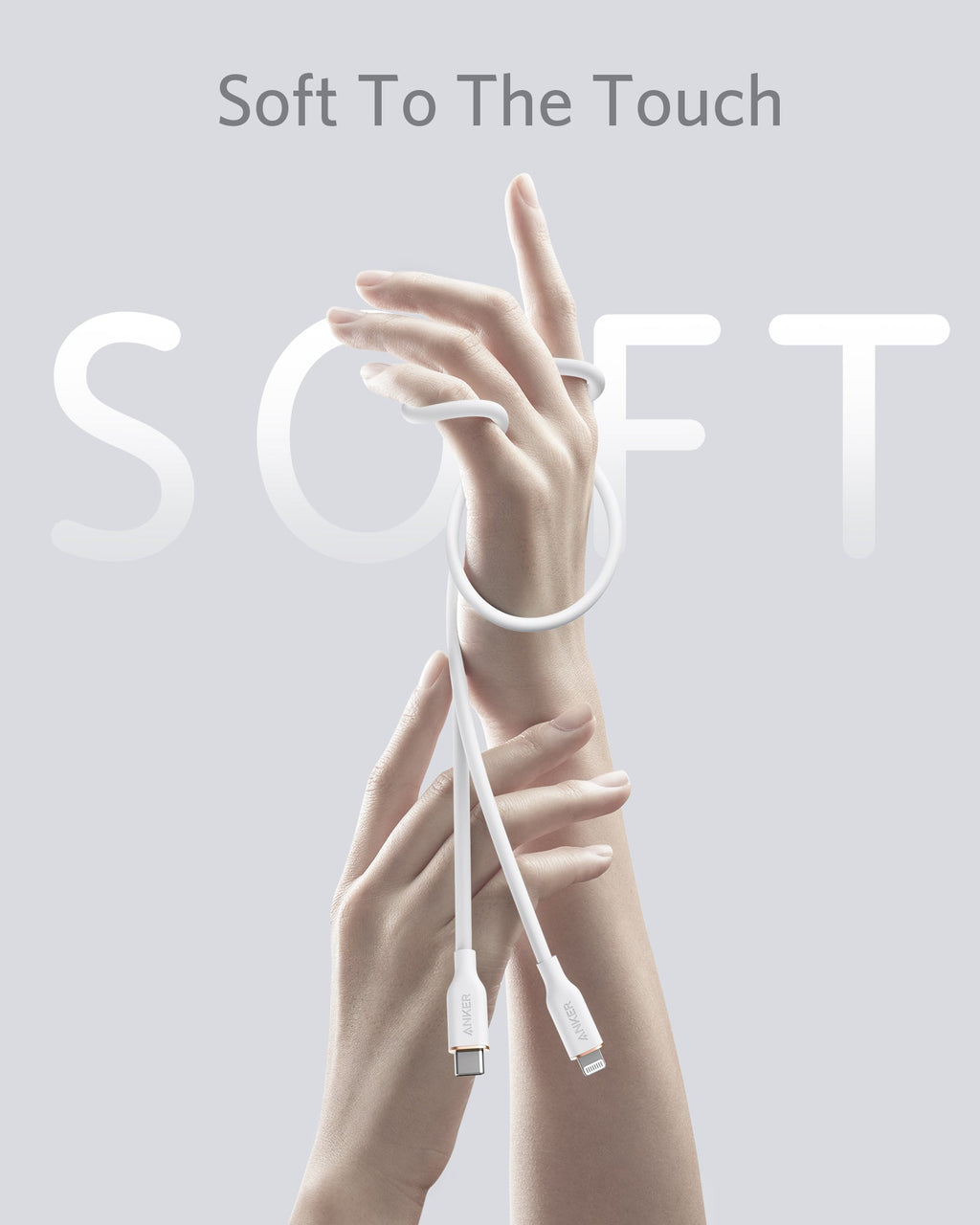 White charging cable with hands holding it against a light gray background