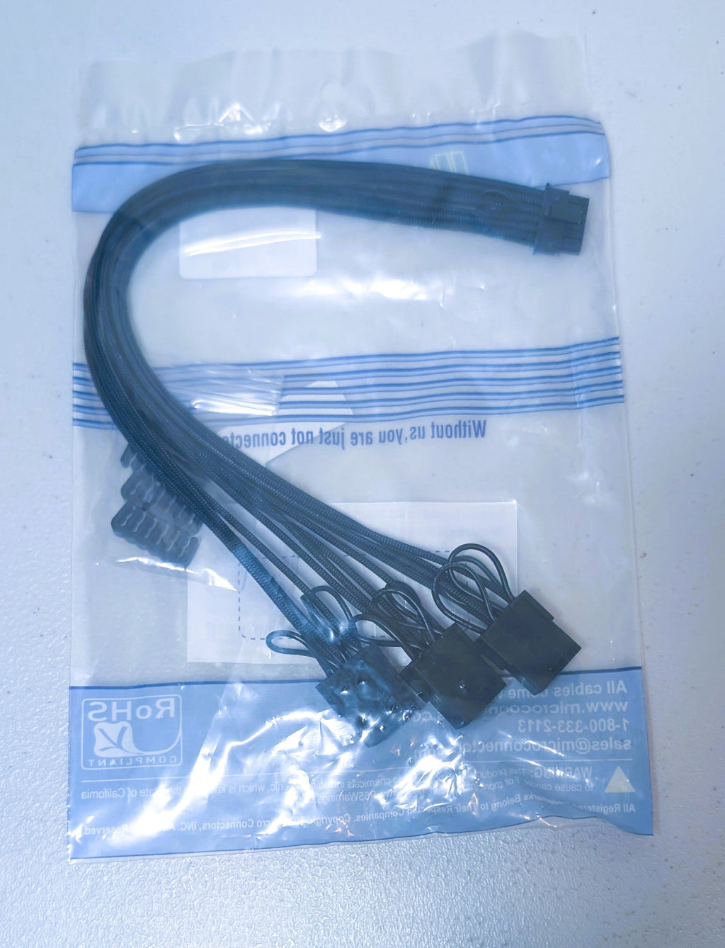Computer cable set in a clear plastic bag with blue labels on a white background