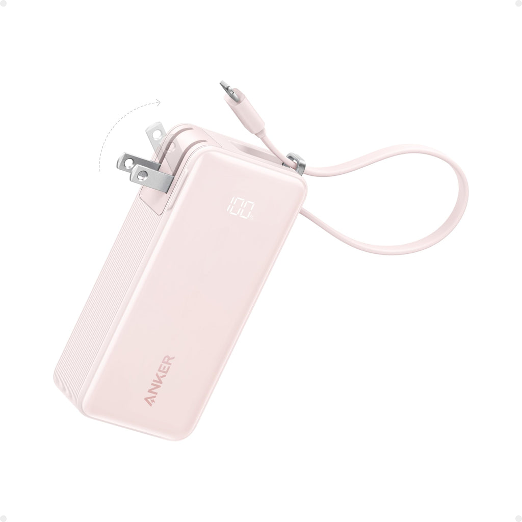 Pink Anker power bank with USB cable on a white background