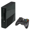 Black gaming console and controller on a white background
