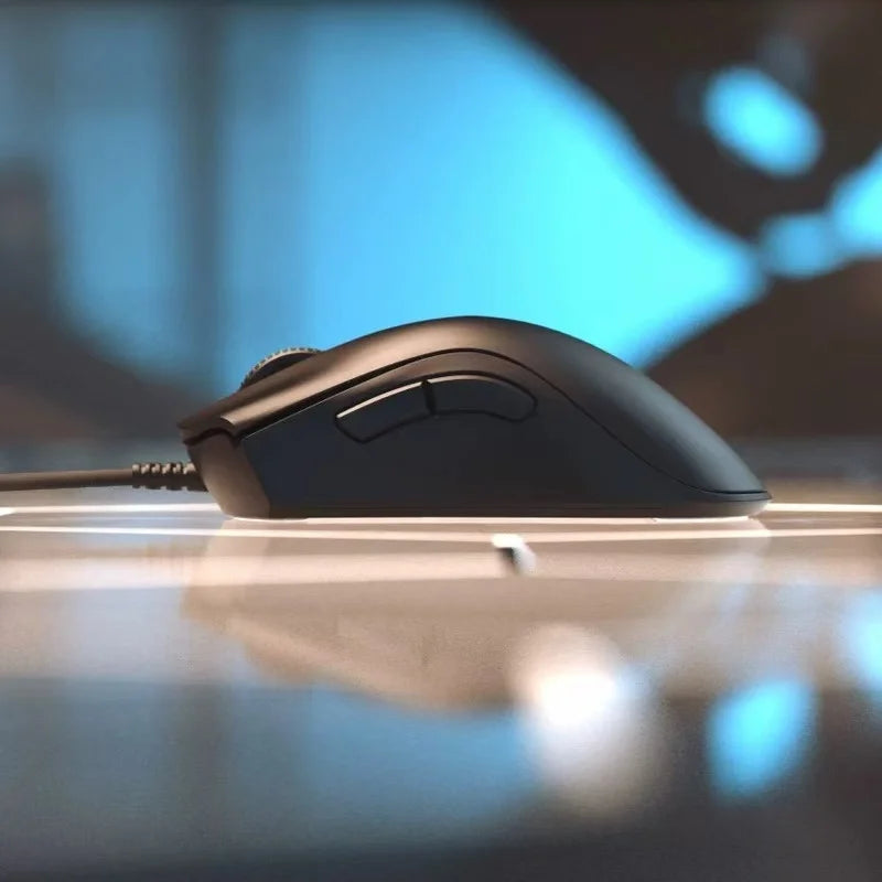 Black computer mouse on a reflective surface with a blurred background