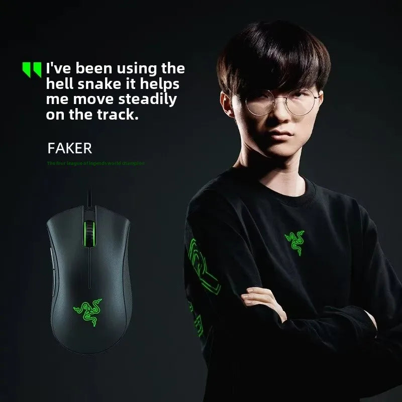 Person wearing a black shirt with Razer logo, next to a gaming mouse, on a dark background.