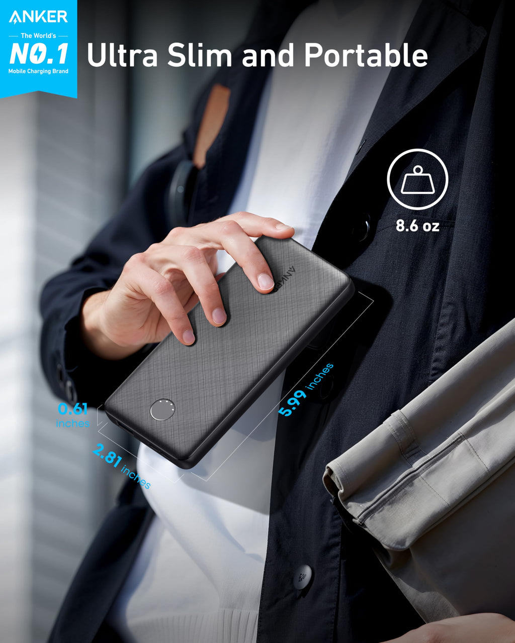 Person holding a black power bank with Anker branding, emphasizing ultra-slim and portable design.