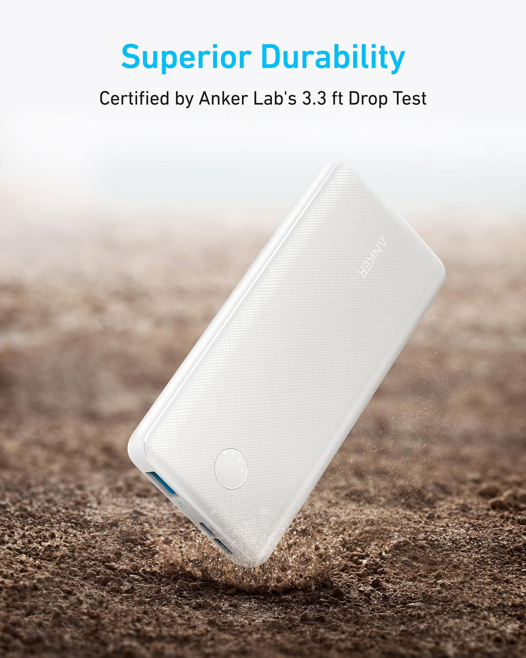 White power bank being dropped on a textured surface with 'Superior Durability' text and Anker Lab certification.