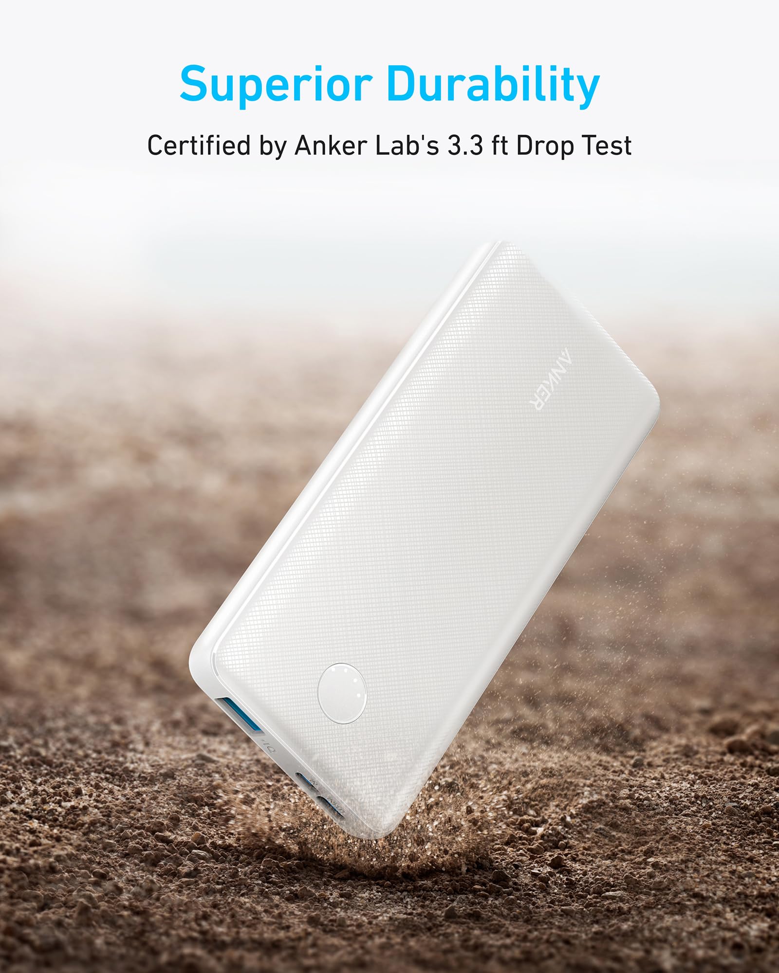 White power bank being dropped on a textured surface with 'Superior Durability' text and Anker Lab certification.