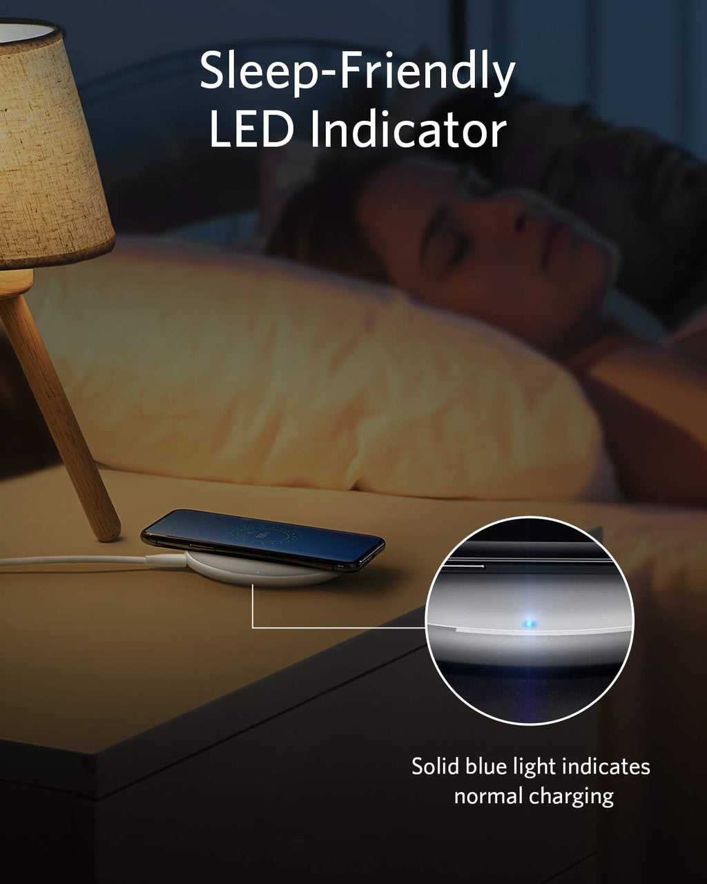 Bedside setup with a phone on a stand, lamp, and text about sleep-friendly LED indicator.