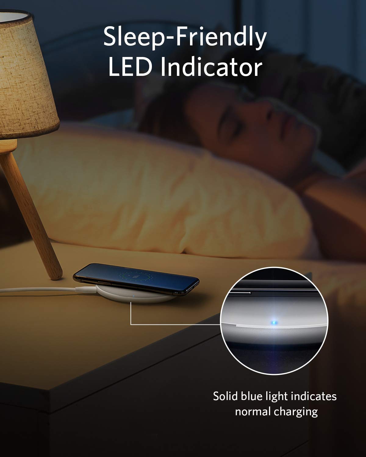Bedside setup with a phone on a stand, lamp, and text about sleep-friendly LED indicator.