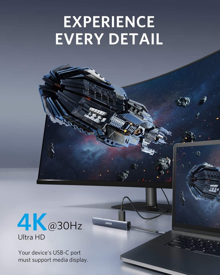 Laptop and monitor displaying space-themed wallpaper with 'Experience Every Detail' text.