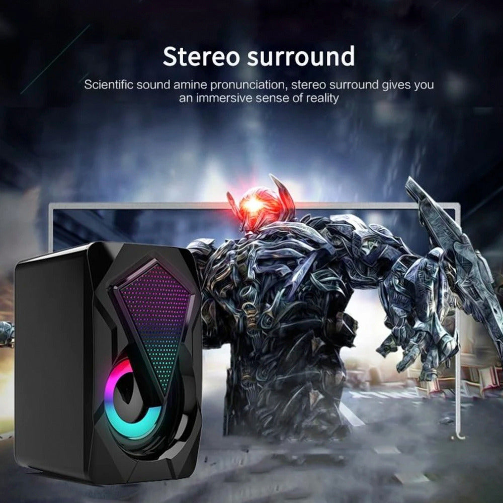 Gaming speaker with RGB lighting in front of a robot statue, emphasizing stereo surround sound feature.