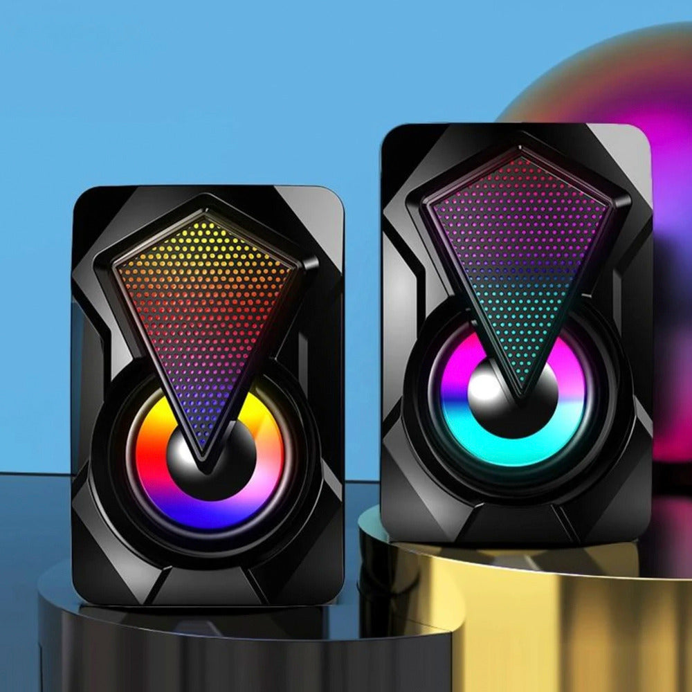 Pair of black speakers with colorful LED lighting on a blue background