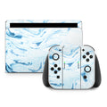 Gaming console and controllers with blue marble design on a white background