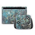 Gaming console and controllers with a blue and gray marble skin on a white background