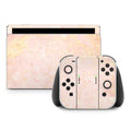 Gaming console and controllers with a marble pattern on a white background