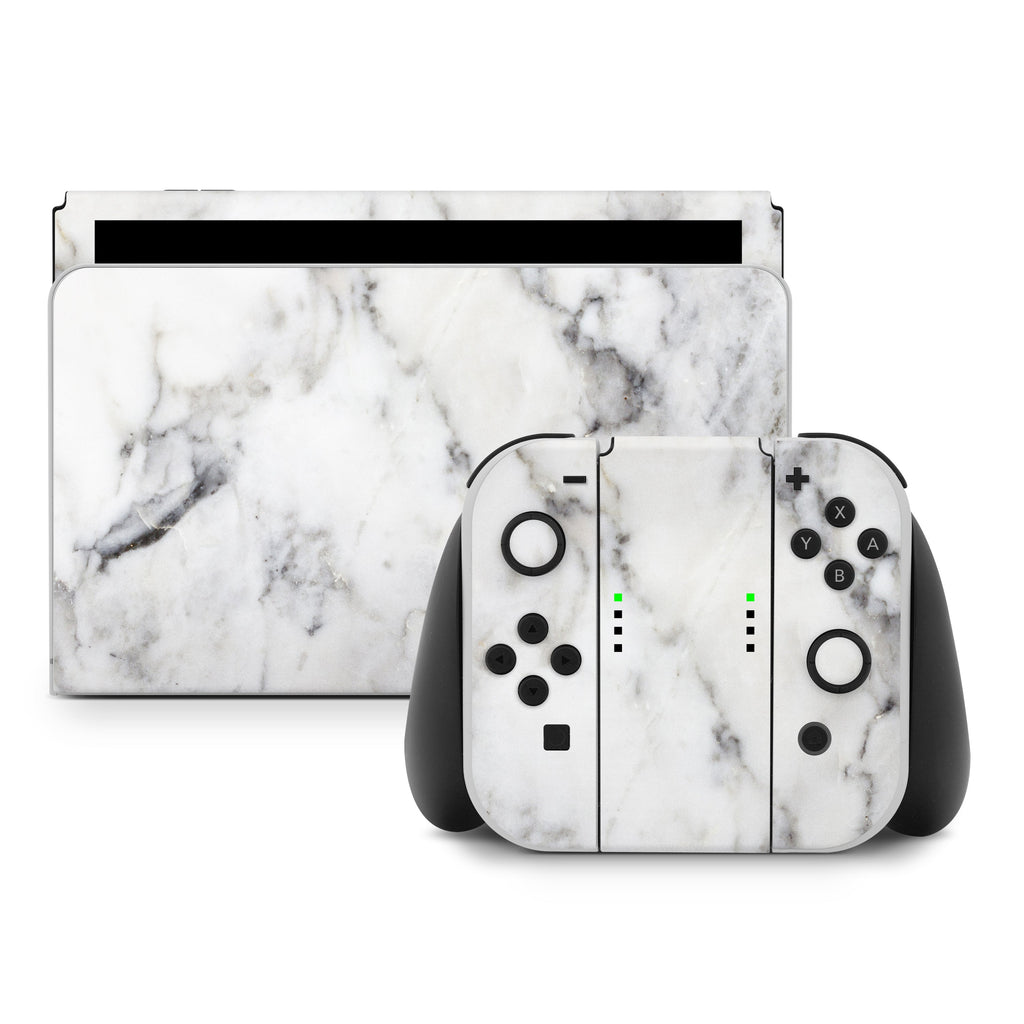 Gaming console and controllers with marble pattern on a white background