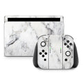 Gaming console and controllers with marble pattern on a white background