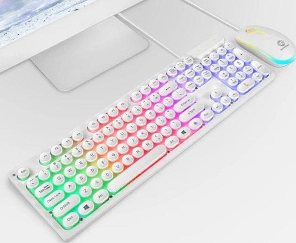 Colorful keyboard on a desk with a computer mouse and monitor in the background