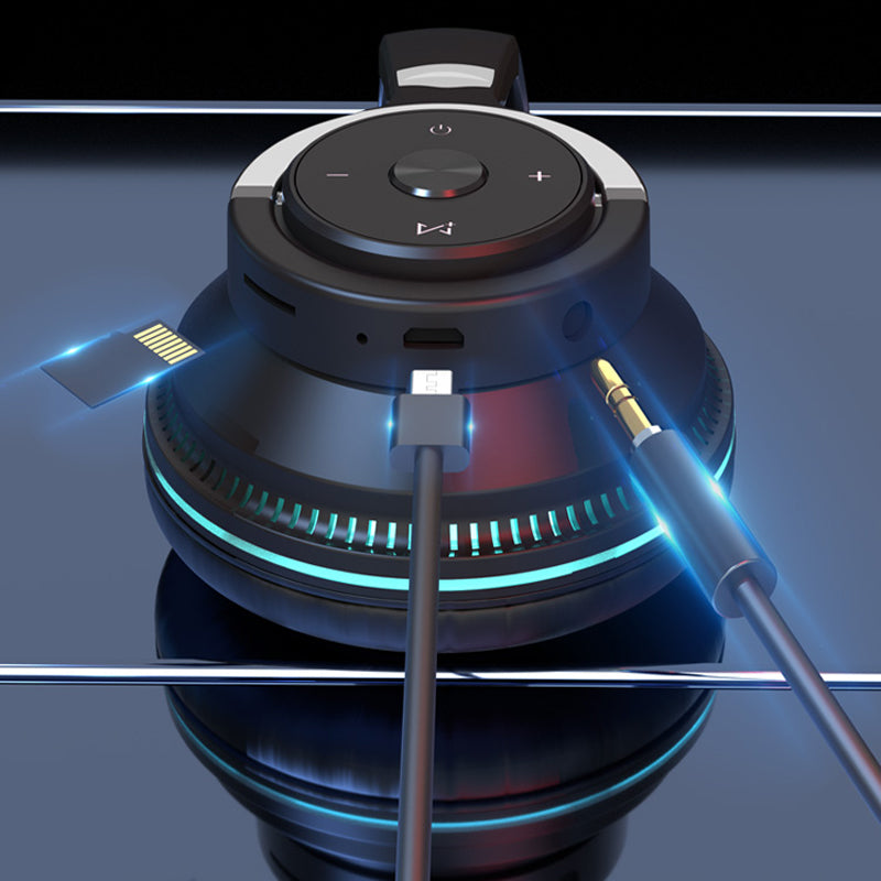 Black and silver audio device with cables on a reflective surface