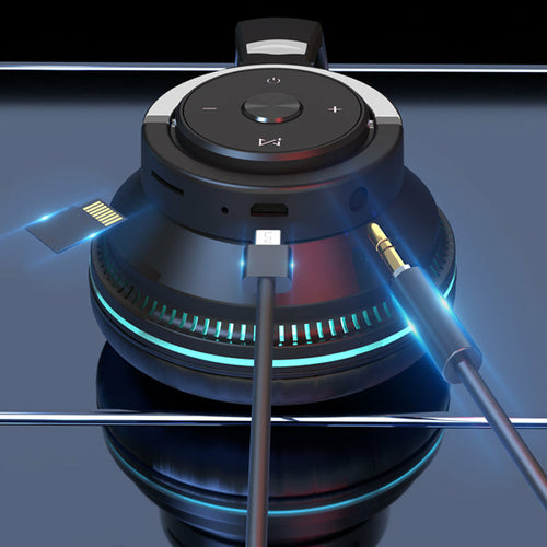 Black and silver audio device with cables on a reflective surface