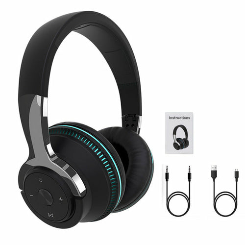 Black headphones with green accents, USB cable, and audio jack cable on a white background