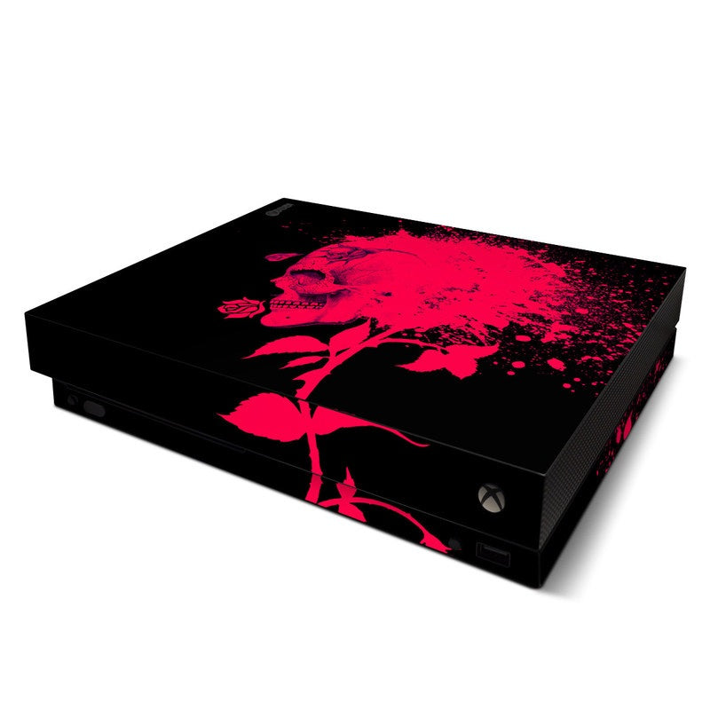 Black gaming console with a pink rose design on a white background