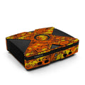 Gaming console with orange and yellow camouflage design on a white background