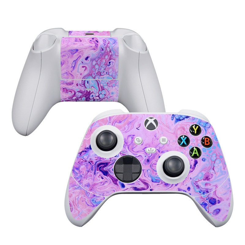 Gaming controller with a purple and pink marbled skin on a white background