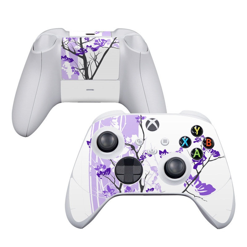 White gaming controller with purple floral design on a white background